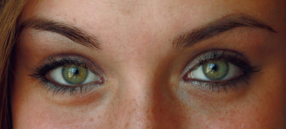 A woman with hazel eyes, the picture zoomed in on her eyes.