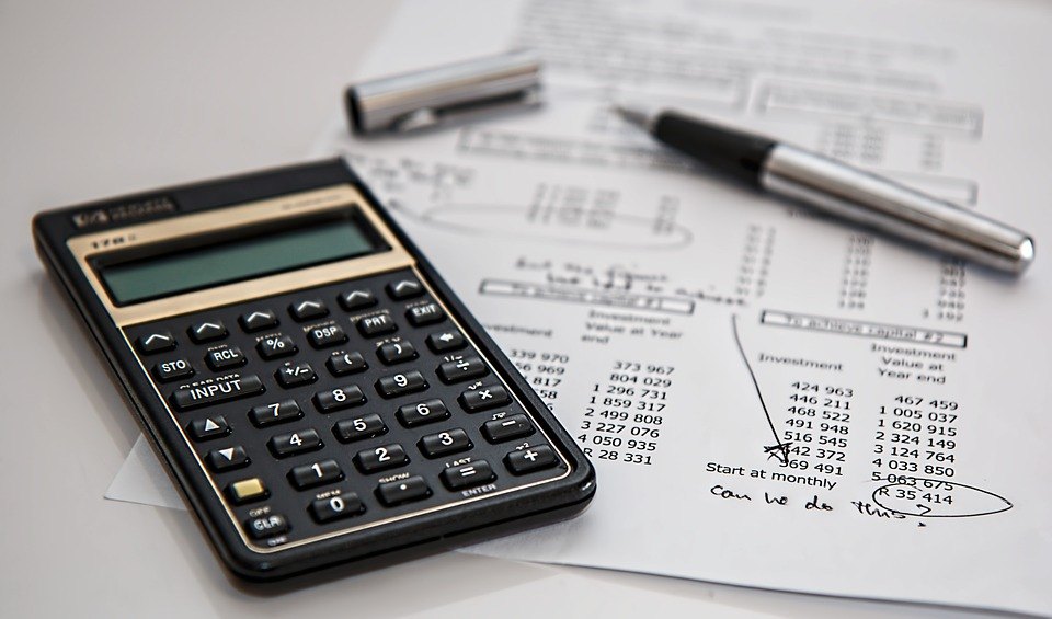 Picture of calculator, pen, and paperwork