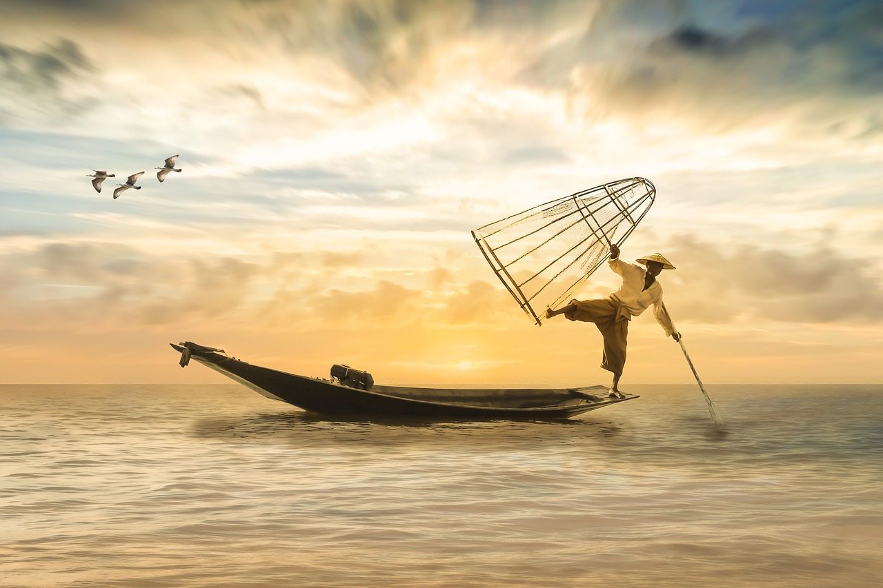Picture of a man preparing to cast his net while fishing