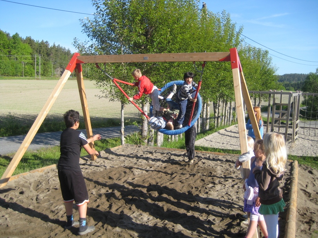 Children playing on a swing set.
