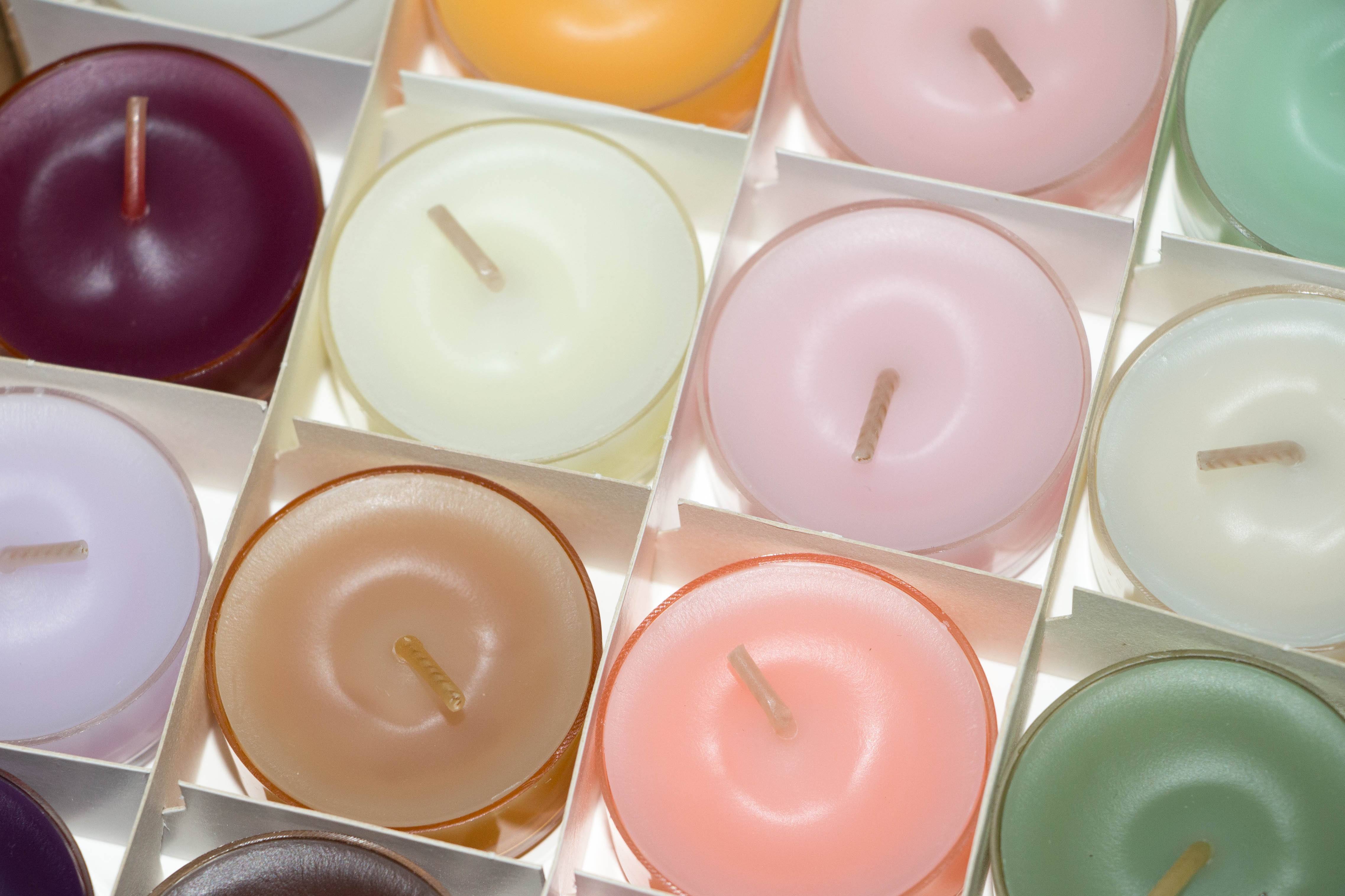 A collection of colorful candles in a tightly packed array