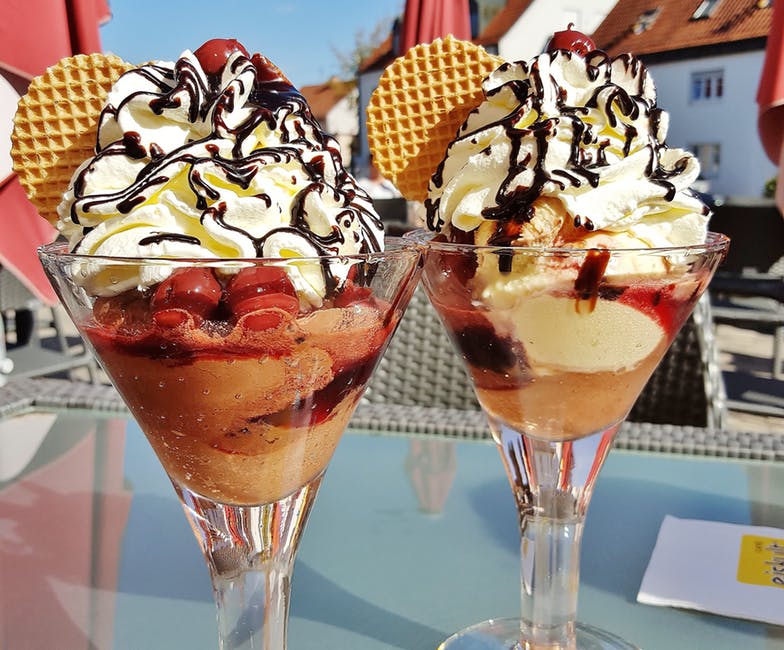 Ice cream sundaes enjoyed in the sunlight. Hope they don't melt!