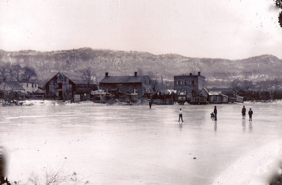 Oil painting of people walking on a frozen lake.