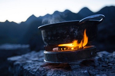 A pan of water on a portable stove, somewhere in the mountains.