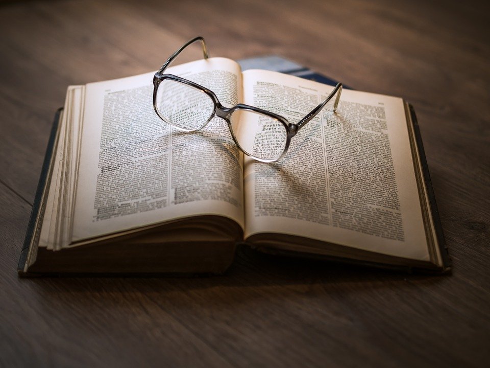 Book with glasses laying on top