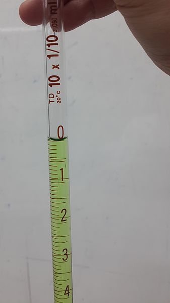 Image of water inside of a pipette, curved at its upper surface.