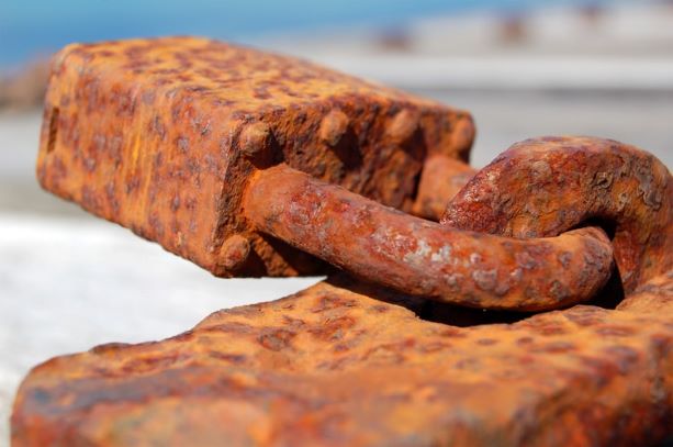 Image description: a pad-lock is covered in a layer of orange-brown rust.