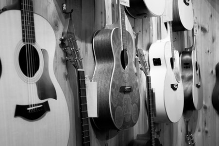 Image of guitars hanging on a wall.