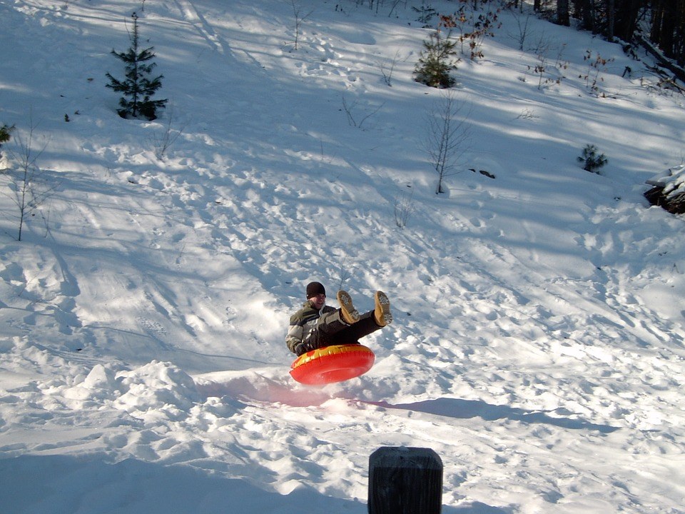 Picture of man snow tubbing