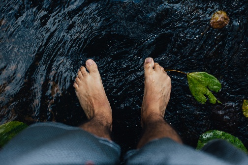 Bare feet in the water.