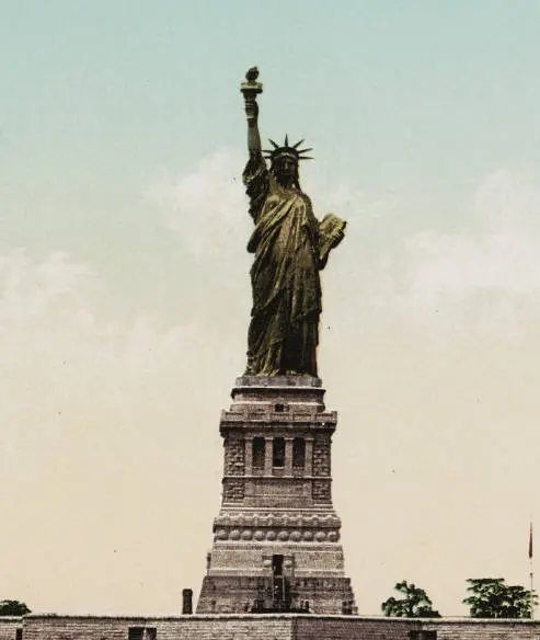 Image description: Statue of Liberty in original color of copper, circa 1900.